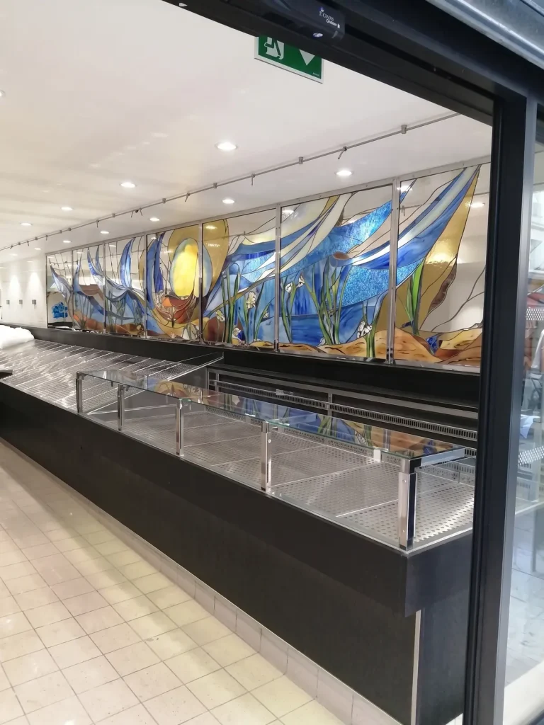 Vitrail décoratif surplombant l’étal réfrigéré de la poissonnerie La Sablaise