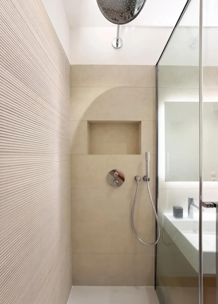 Douche à l’italienne avec niche maçonnée et faïence nervurée, appartement Lathuille